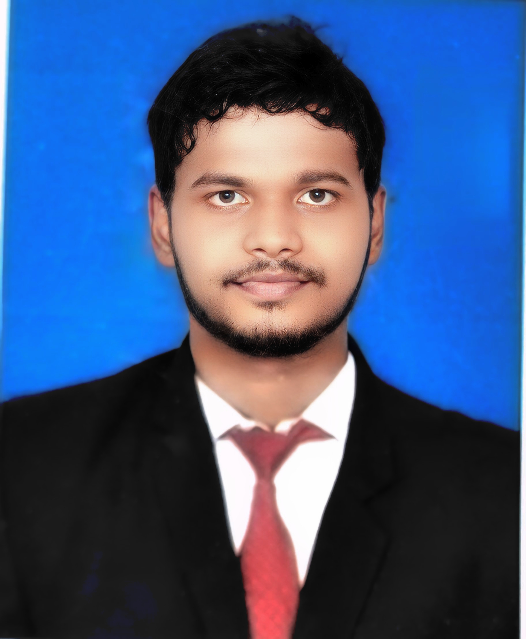 Portrait of Samson Jeba, a young professional wearing smart casual attire with a friendly smile